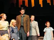 Actors on stage in Annie.