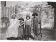 Four children standing side by side