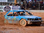 Blue car in demolition derby is covered with dirt and mud.