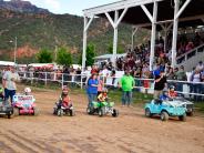 Kids participate in demolition derby in mini cars. 