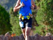 Man in blue shirt running the Parowan Half Marathon. 